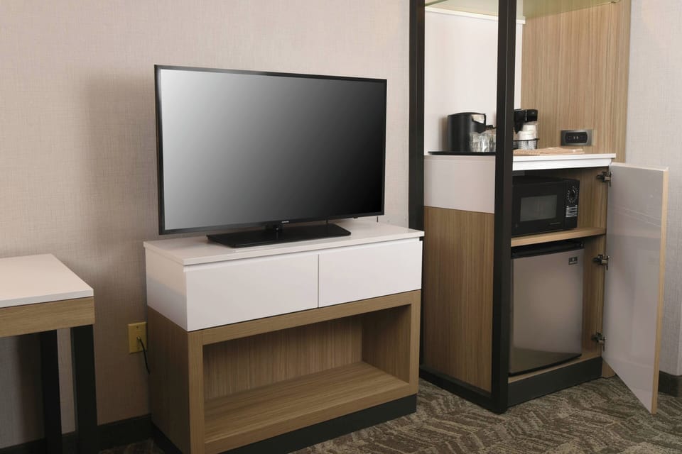 Premium bedding, desk, laptop workspace, blackout drapes