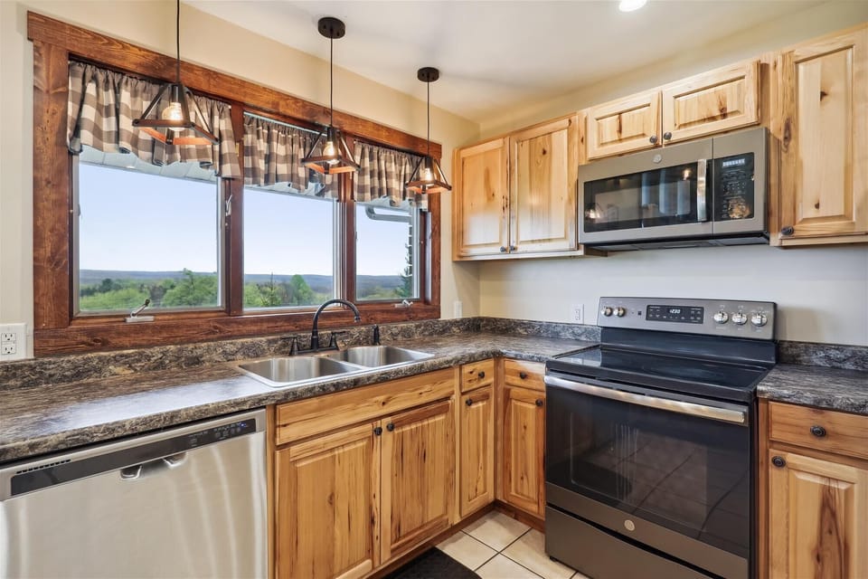 Updated kitchen stocked with all essentials including pots, and pans.