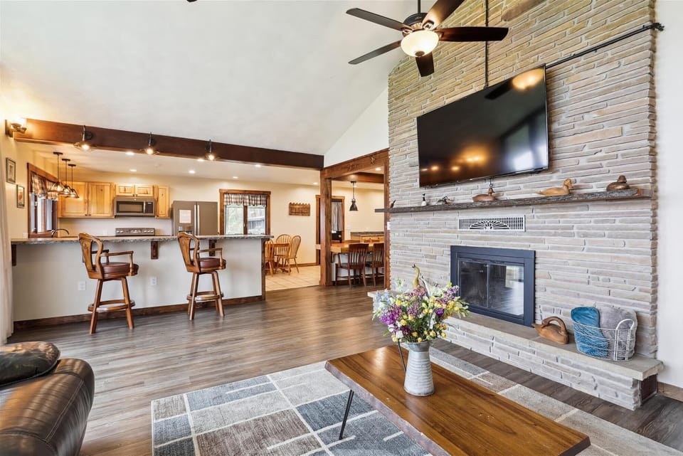 Spacious living room with open floor plan to kitchen and dining area on upper level