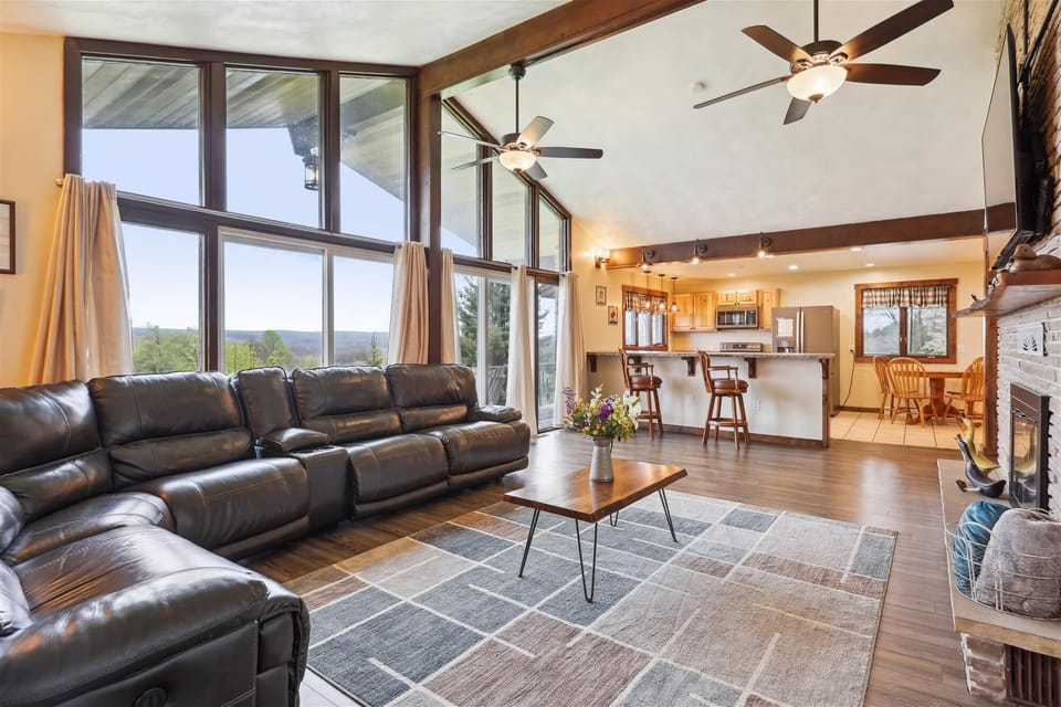 Spacious living room with plenty of natural light on upper level