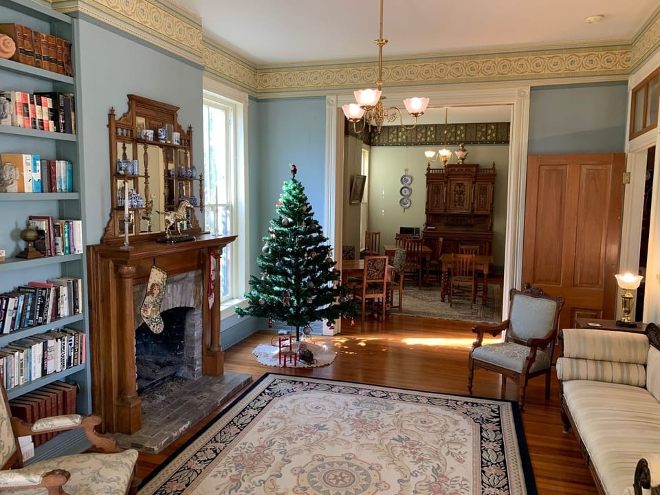 View of parlor/living room looking through doorway into dining room