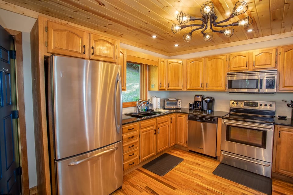 Kitchen with Stainless Appliances, Wood Floors, Tongue-in-Groove Wood Ceiling