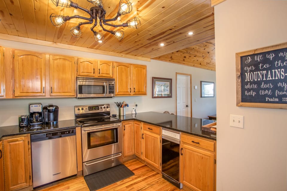 Kitchen with Granite Countertops and a pass-through Bar Top open to Dining and Great Room
