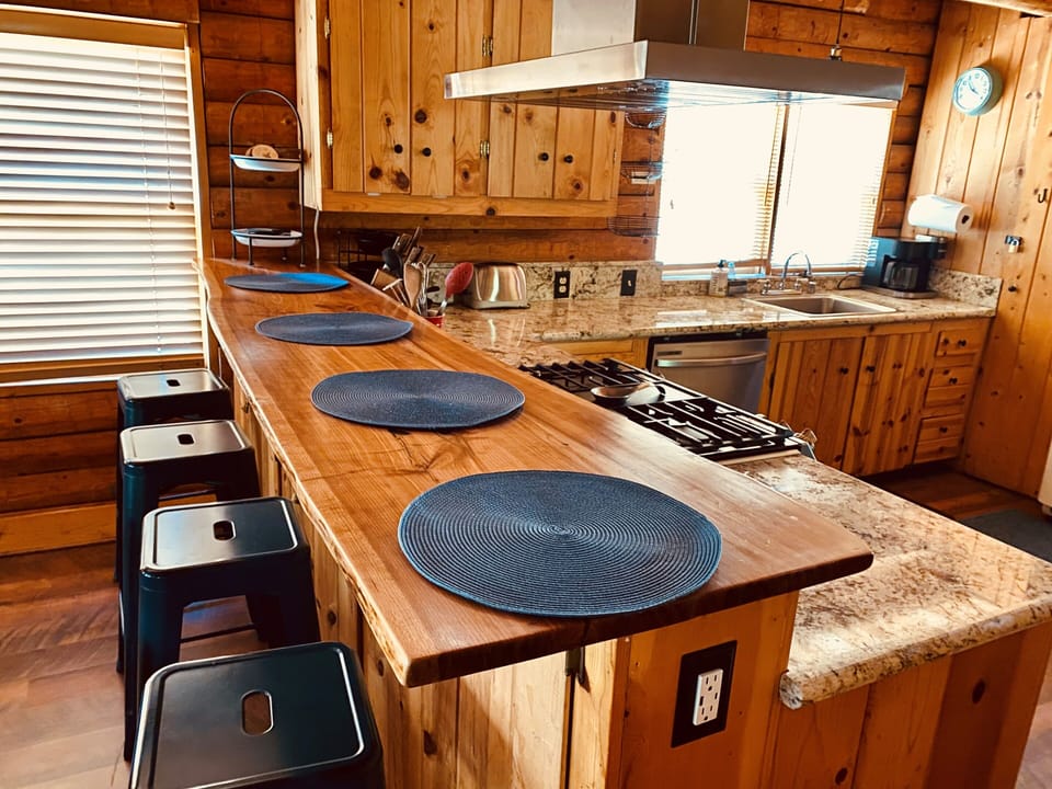 Beautiful Cherry kitchen bar great for breakfast and socializing during cooking.