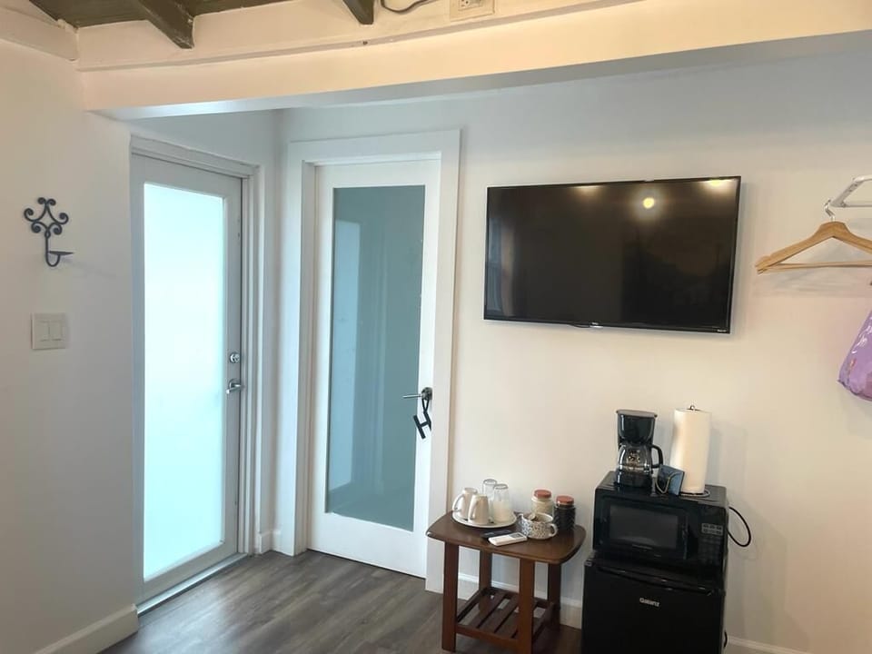 Smart tv in front of the bed.