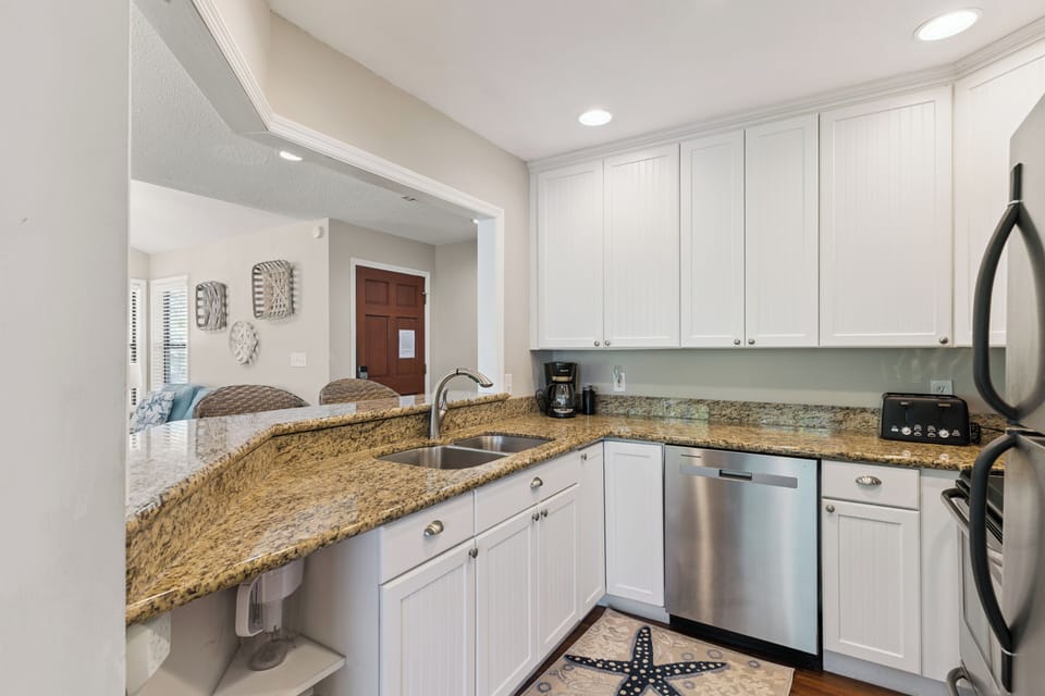 Step into your fully-equipped kitchen with granite counters, stainless appliances, and everything you need to feel right at home during your stay.