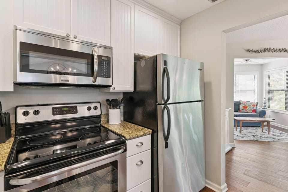 Step into a fully-equipped kitchen with stainless steel appliances and granite countertops, perfect for preparing your favorite meals during your stay.