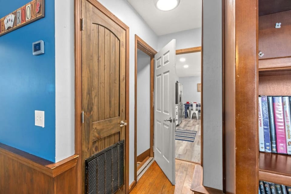 Hall to full bath, kitchen, dining, & laundry. Stairs to bottom floor on left.