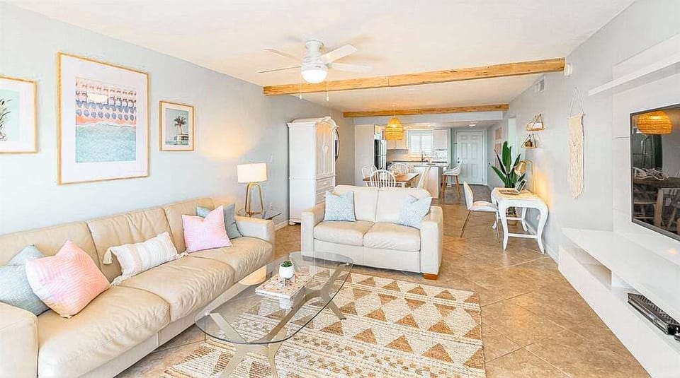 An open concept living space with a cozy pullout couch and natural light