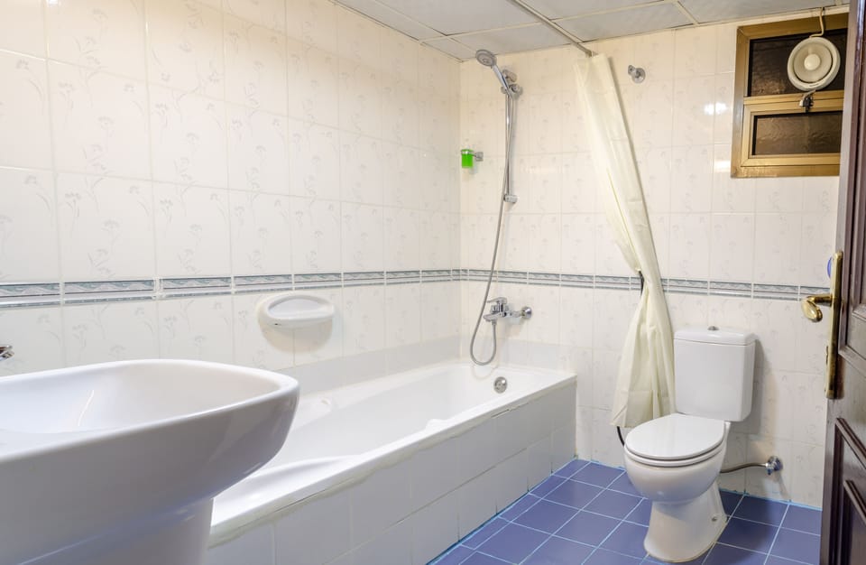 Combined shower/tub, designer toiletries, hair dryer, slippers