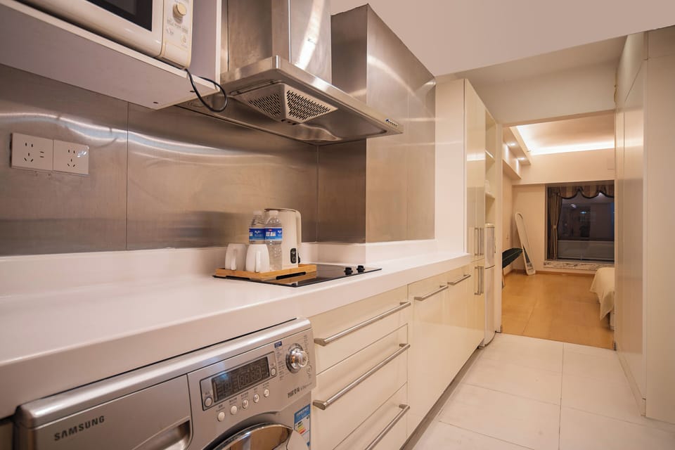 Full-size fridge, microwave, cleaning supplies, paper towels