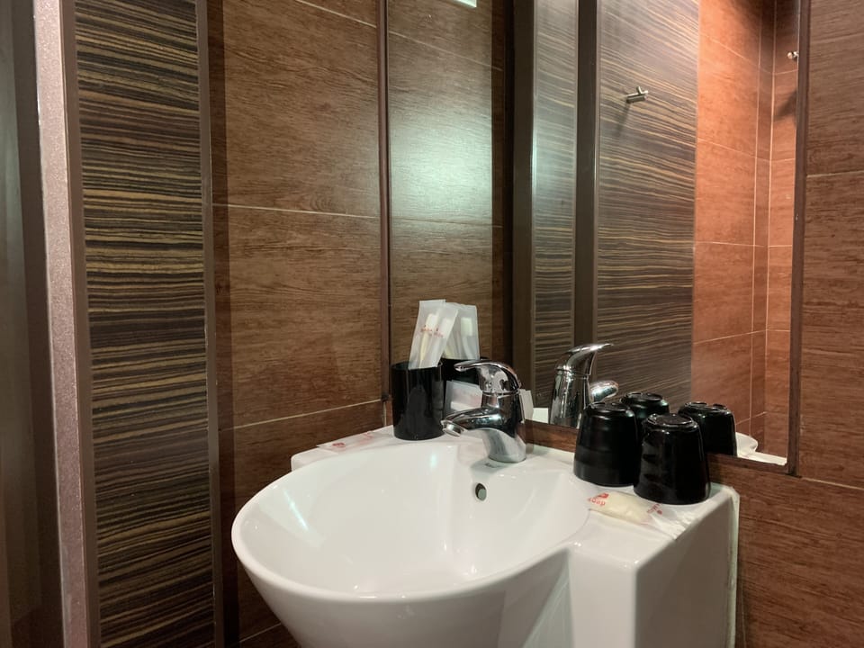 Shower, hair dryer, slippers, towels