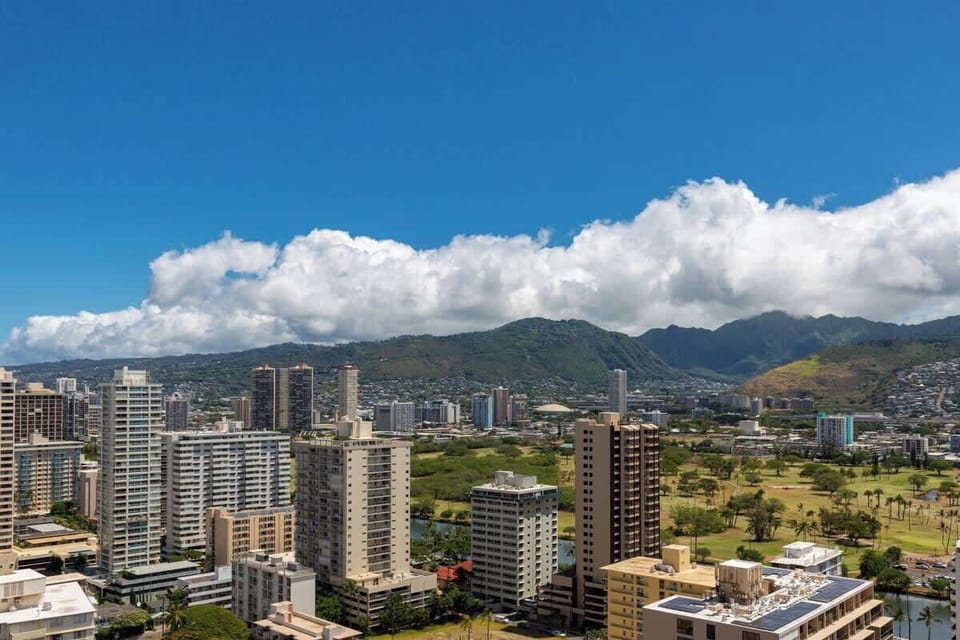 City skyline with mountain views under a clear blue sky