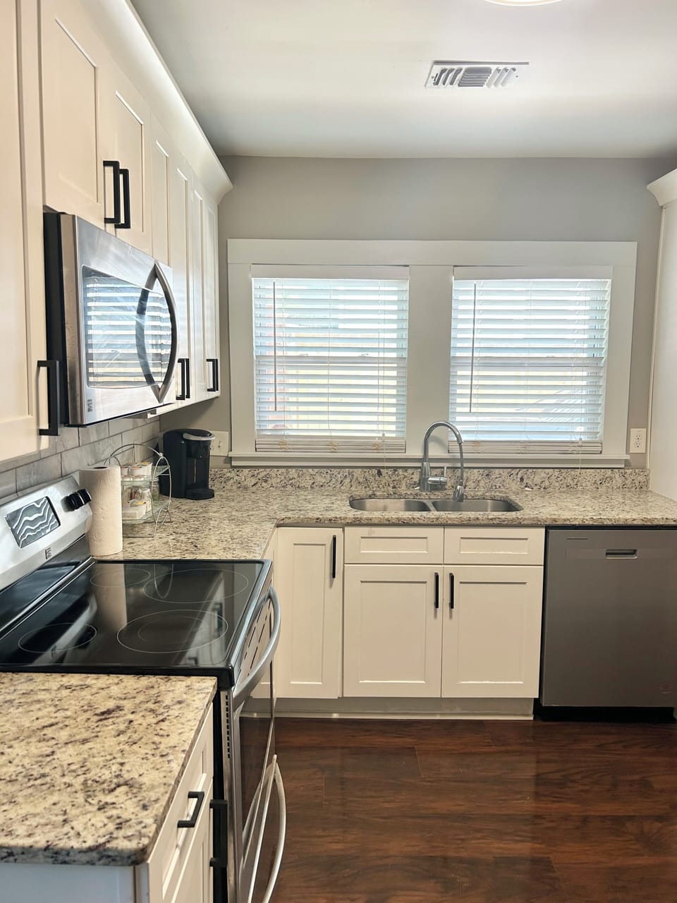 Kitchen: stainless steel appliances, matte black hardware, dual sided fridge.