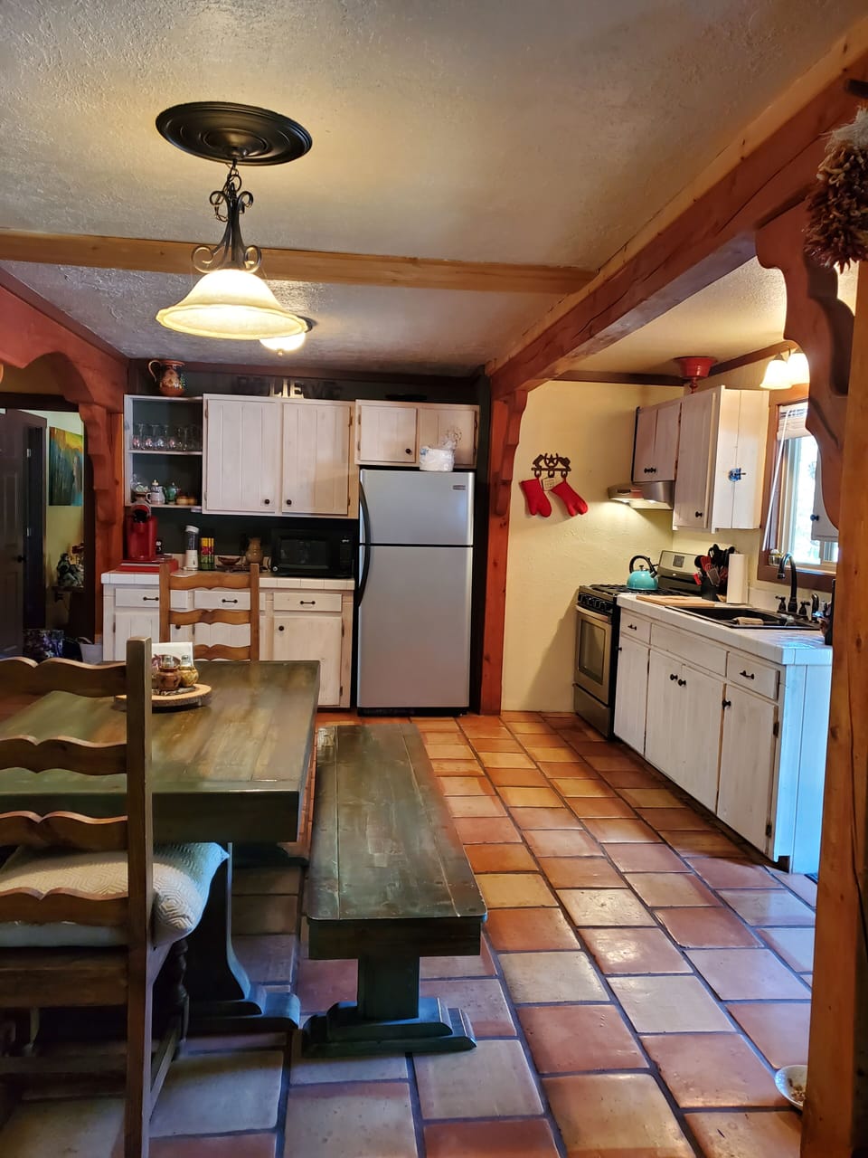 View into Dining, Kitchen from Living, 5 burner gas stainless steel oven & frig