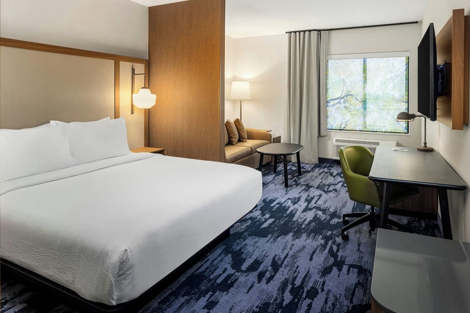Premium bedding, desk, laptop workspace, blackout drapes