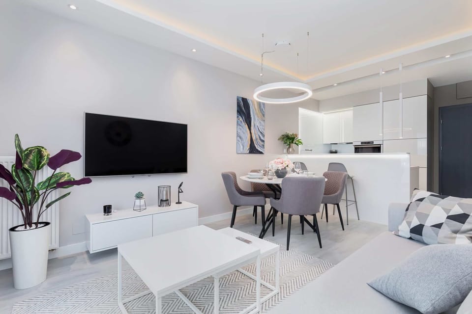 A small living area with a white coffee table, simple furniture, and an inviting ambiance.