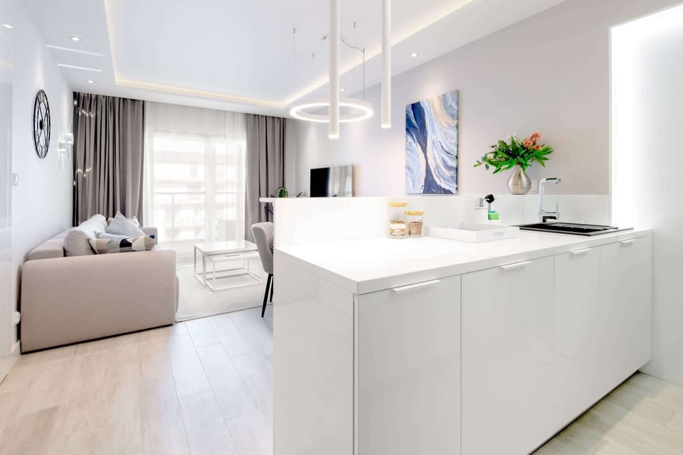 A comfortable living room with floor-to-ceiling windows allowing ample light and ocean views.