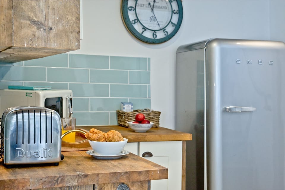 Kitchen with toaster, microwave - Birdcage Cottage