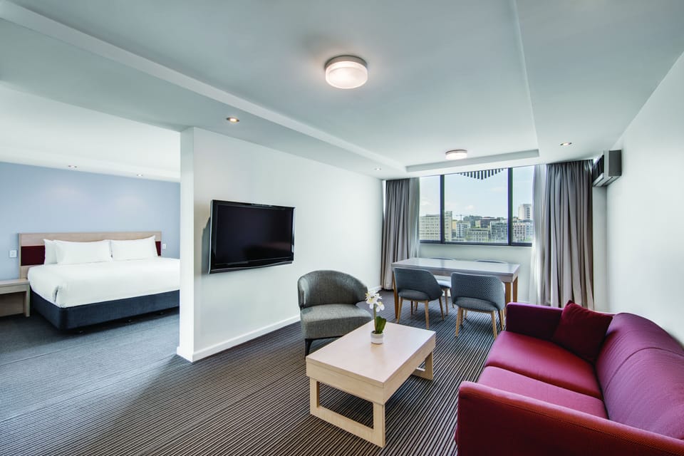 Junior Suite | Living area | 50-inch LCD TV with cable channels, TV, Netflix