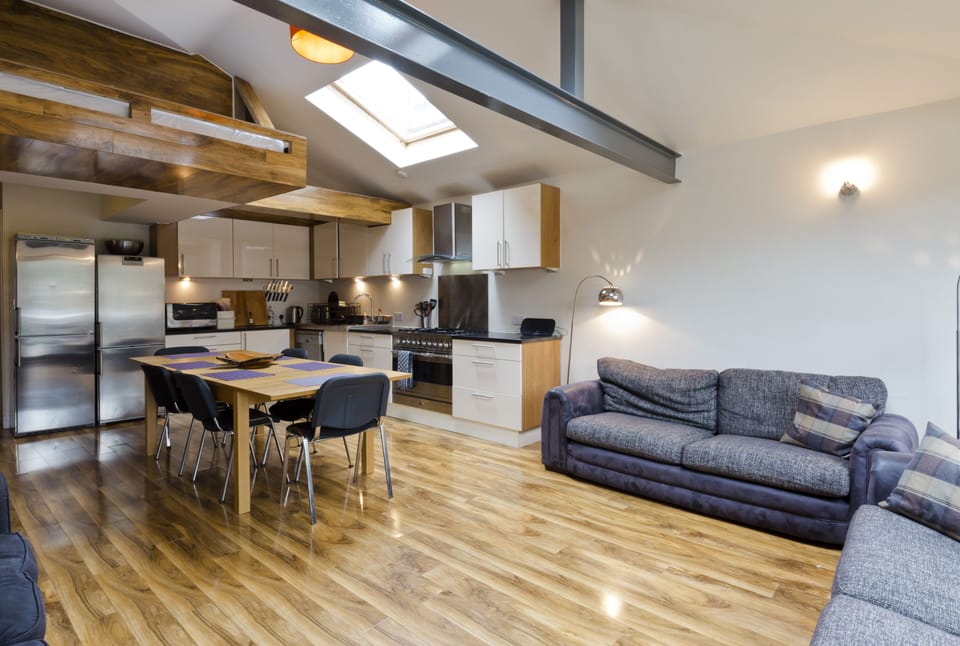 Large kitchen, dining and living room. Table and sofas seat 6