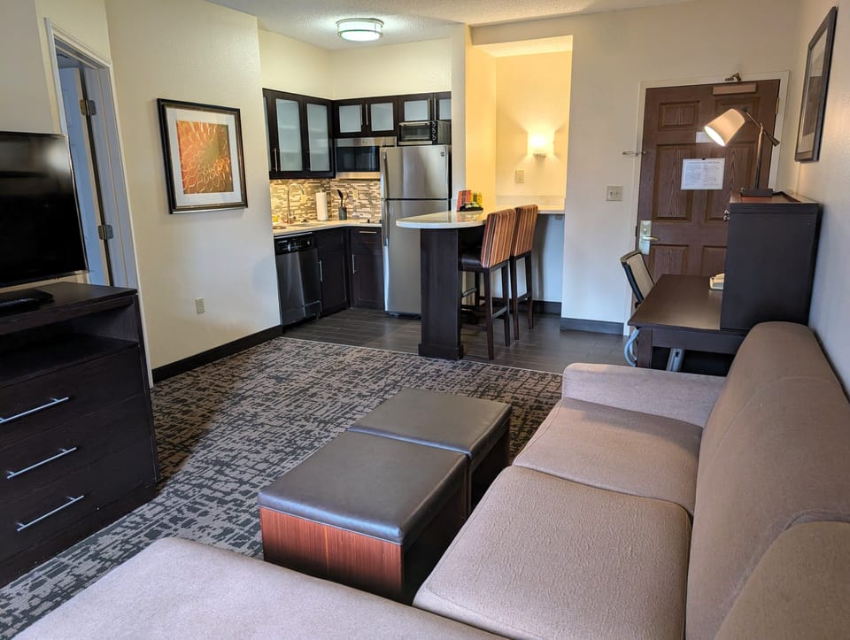 Premium bedding, desk, laptop workspace, blackout drapes