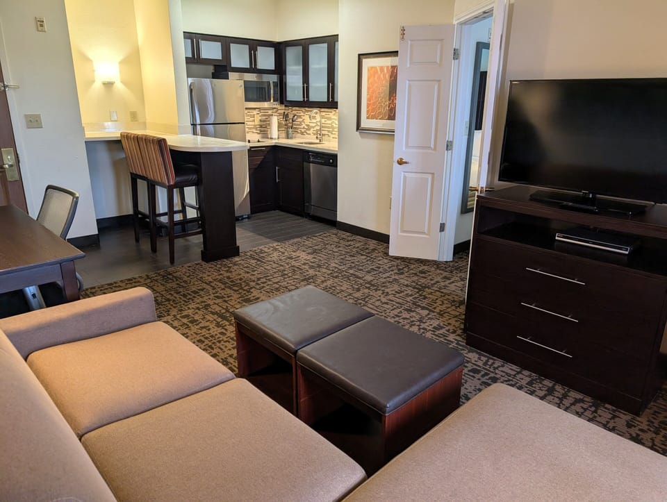 Premium bedding, desk, laptop workspace, blackout drapes