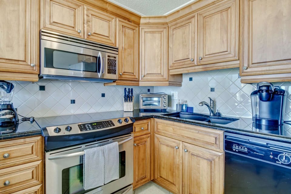 The kitchen is complete with upgraded appliances, cooking tools, dishes, glasses and serving ware.