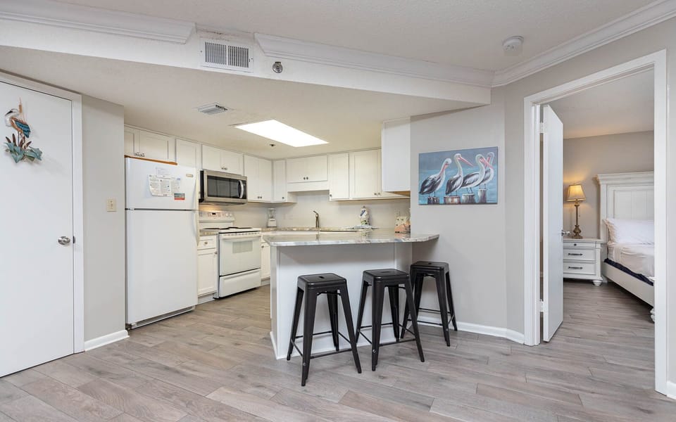 Gather around the sleek kitchen bar with stools, perfect for casual meals and conversation