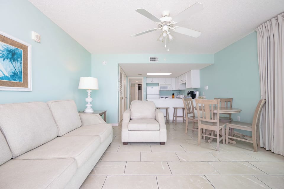 Unwind in the inviting living area, featuring a comfortable sofa and easy access to the kitchen and dining space