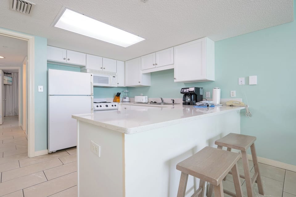 Prepare meals in this kitchen featuring a breakfast bar and ample counter space for dining and entertaining