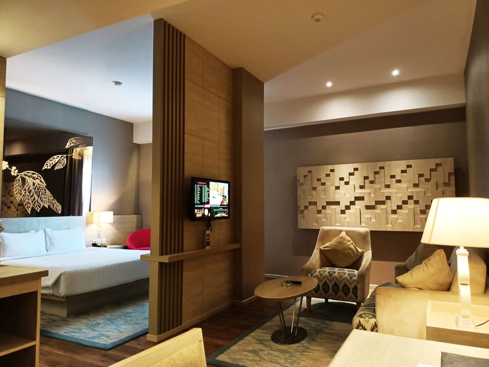 Junior Double Room, 1 King Bed | Living area | 32-inch LED TV with satellite channels, TV