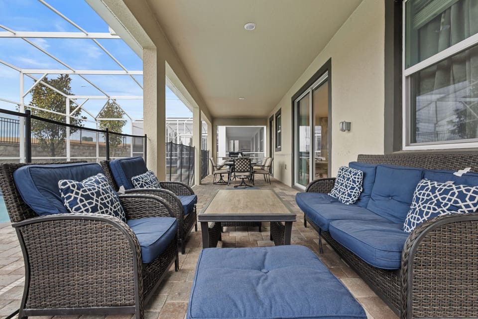Unwind on your private covered terrace with plush blue seating, perfect for morning coffee or evening relaxation.