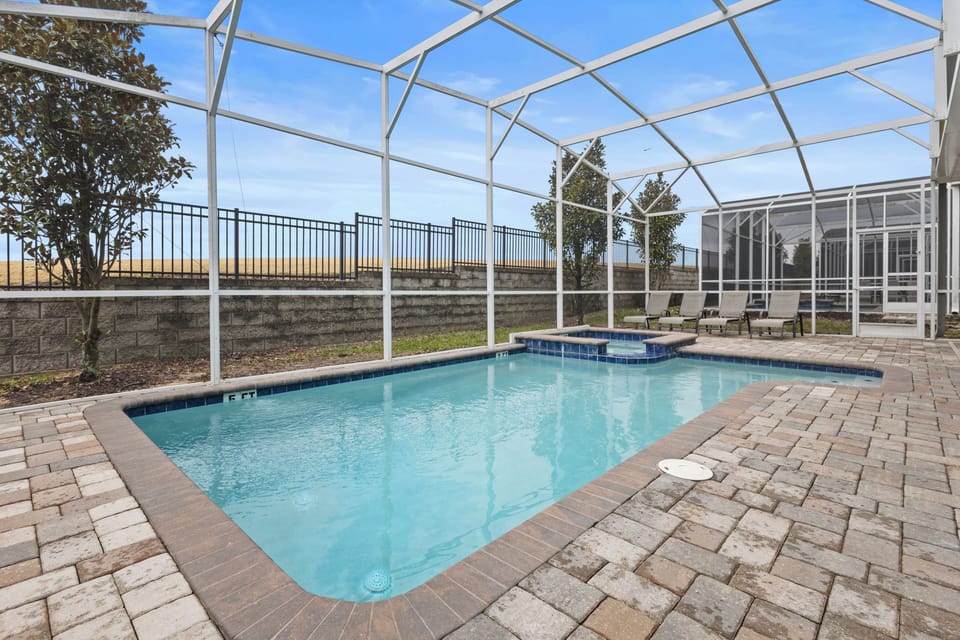 Step into your private oasis! Dive into the sparkling pool or unwind in the spa, all under a protective screen enclosure with peaceful views.