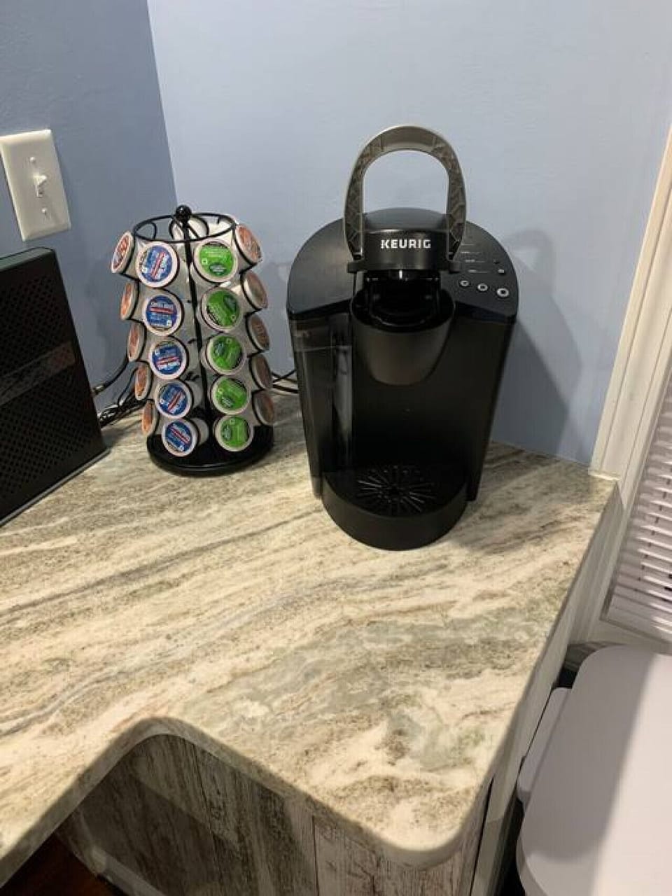 Complimary variety of K-cups with cream and sugar provided for guests