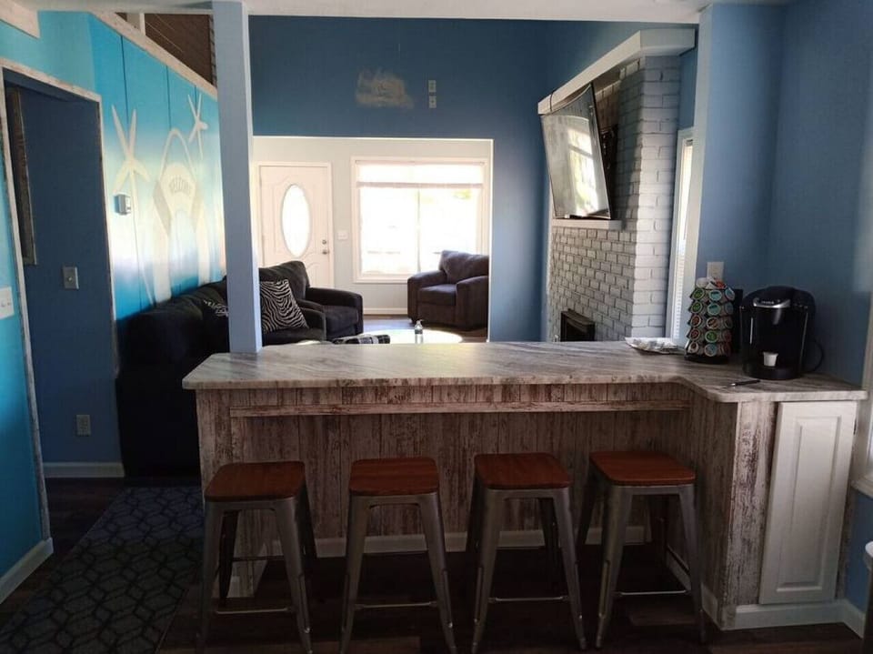 View of snack bar and living room from kitchen