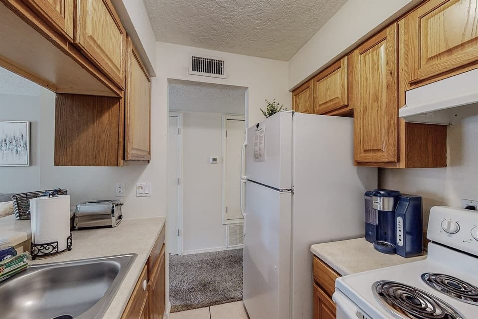 Kitchen includes refrigerator, electric stove, microwave, dishwasher and coffee maker available