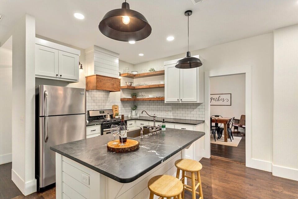 Our kitchen was made for entertaining! A gorgeous kitchen island, subway tiled back splash, farmhouse lighting details, and all new appliances make this kitchen a 10/10. Walk through the kitchen straight into the dining area!