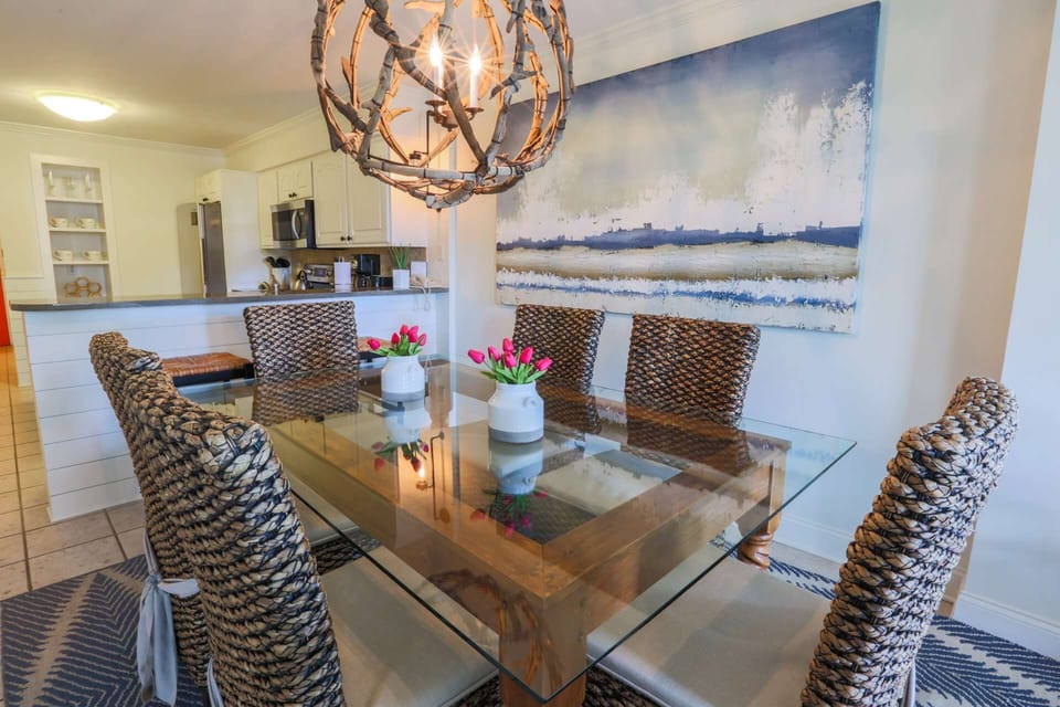 The dining table comfortably seats 6 people.  There are also 2 stools alongside the kitchen counter.