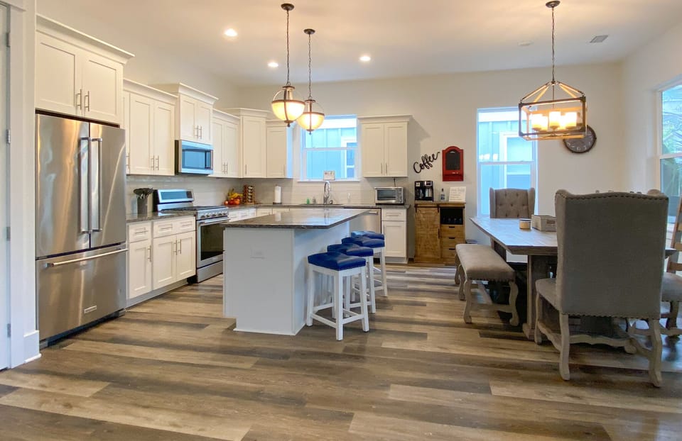 Large chef kitchen with seating for 13 and 3 more at high top table.