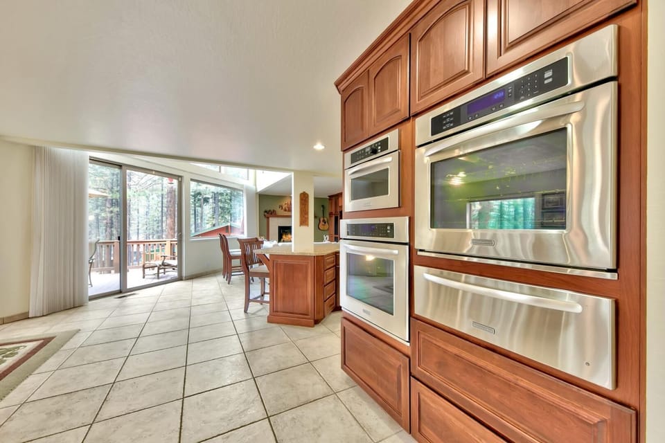 Your gourmet kitchen features rich wood cabinetry and premium stainless steel appliances, perfect for creating memorable meals together.