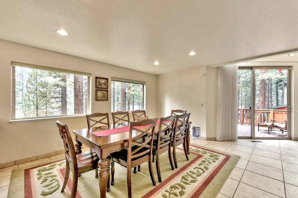 Gather around this elegant dining table for memorable meals with forest views streaming through your windows and easy deck access.