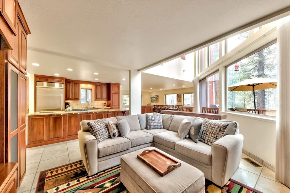 Unwind in your spacious living room with plush sectional seating and stunning views through floor-to-ceiling windows that fill the space with natural light.