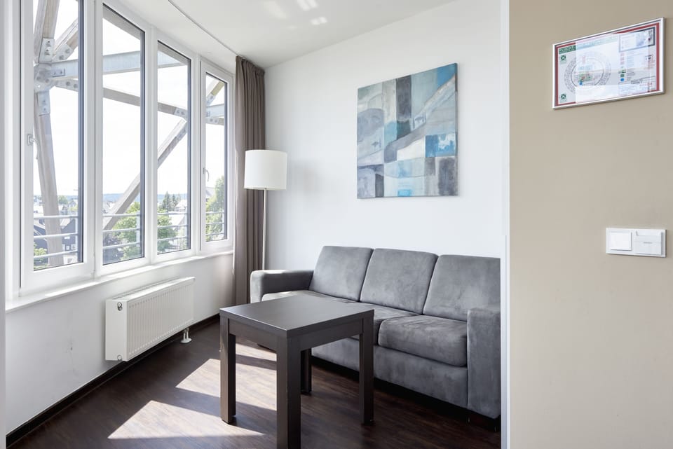 Deluxe Suite | Living area | 32-inch LCD TV with satellite channels, TV