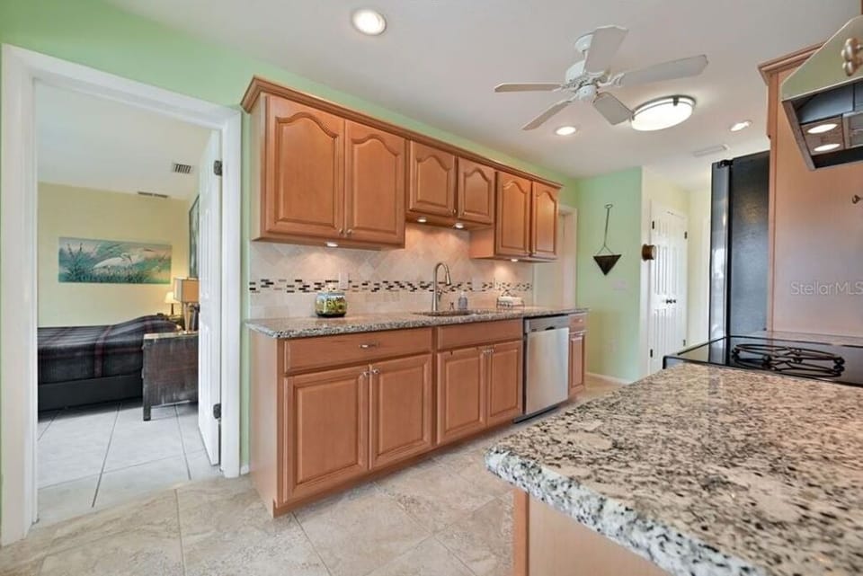 Kitchen with granite counter tops and stainless steel appliances.