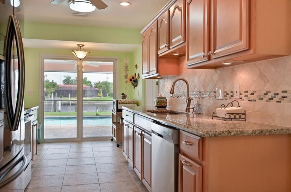 Fully stocked kitchen with granite counter tops and direct access to Lanai. 