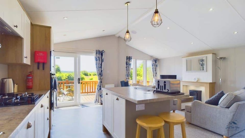 Open-plan kitchen, living and dining area with access to the wraparound balcony.