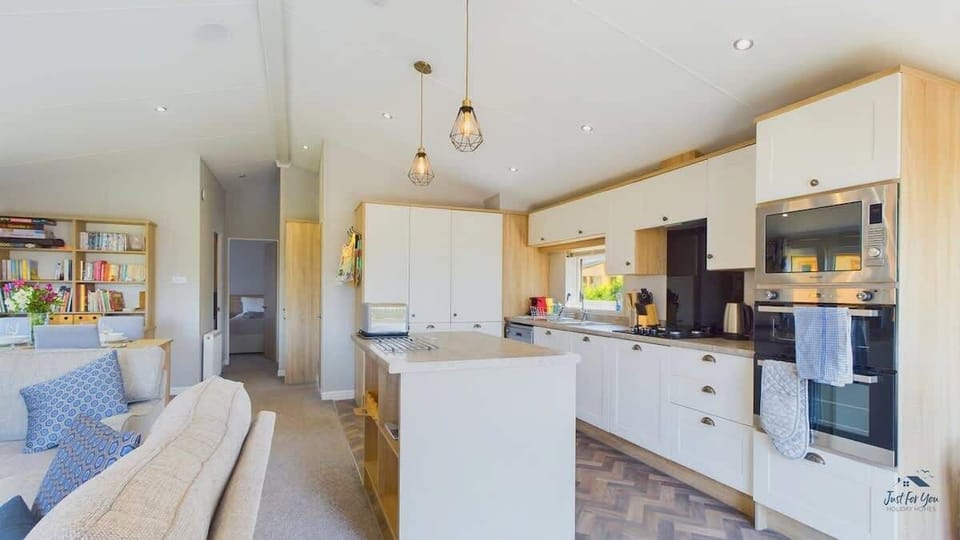 Close-up of kitchen appliances at Poppy Lodge, including fridge, oven and coffee maker — perfect for self-catering stays.
