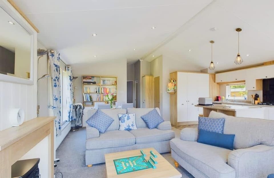Alternate view of the open-plan living area showing additional sofa seating and natural light.

