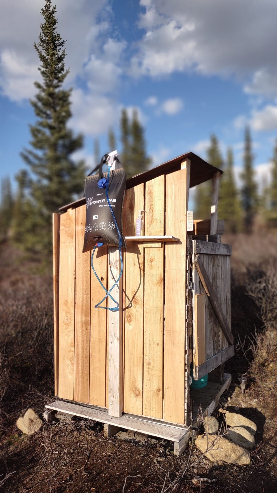 private composting outhouse with gravity shower for washing. 